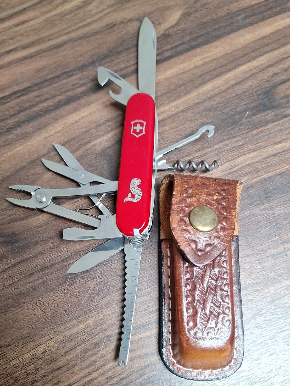 Victorinox Red Swiss Army Multi-Tool with Leather Pouch. Has fishing logo.